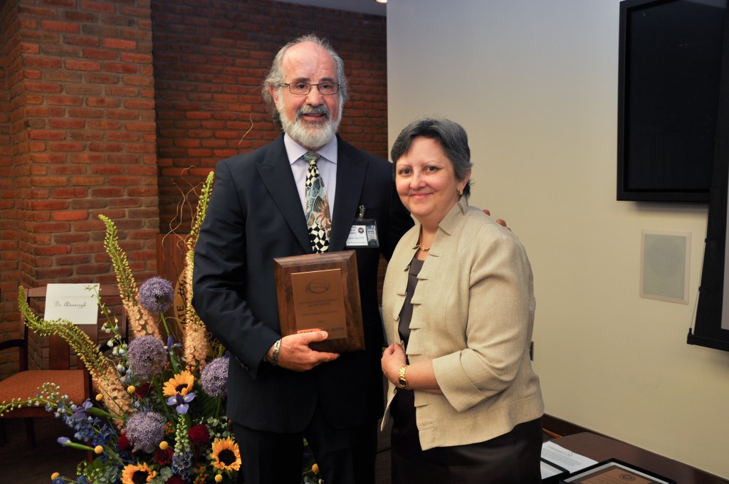 Diane T. Adamczyk, OD, FAAO Director of Residency Education presenting the Award to Dr. Sanet